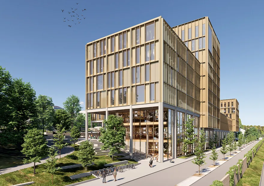 Moderne høye kontorbygninger med store vinduer omgitt av grønne trær og en gangvei under blå himmel.