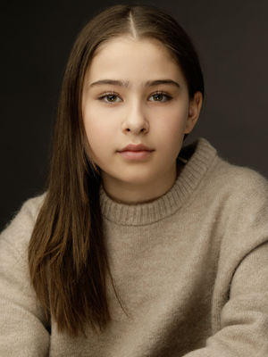 Seraphine Krystek Head shot wearing beige sweater.