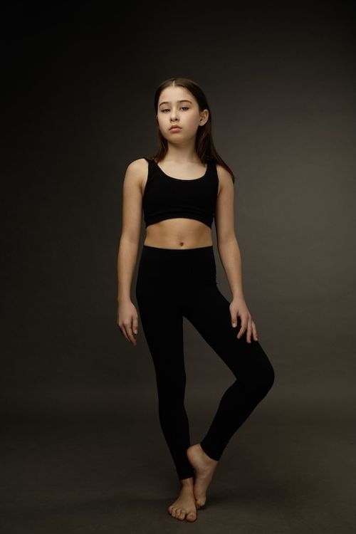 Seraphine Krystek full body standing wearing workout wear.