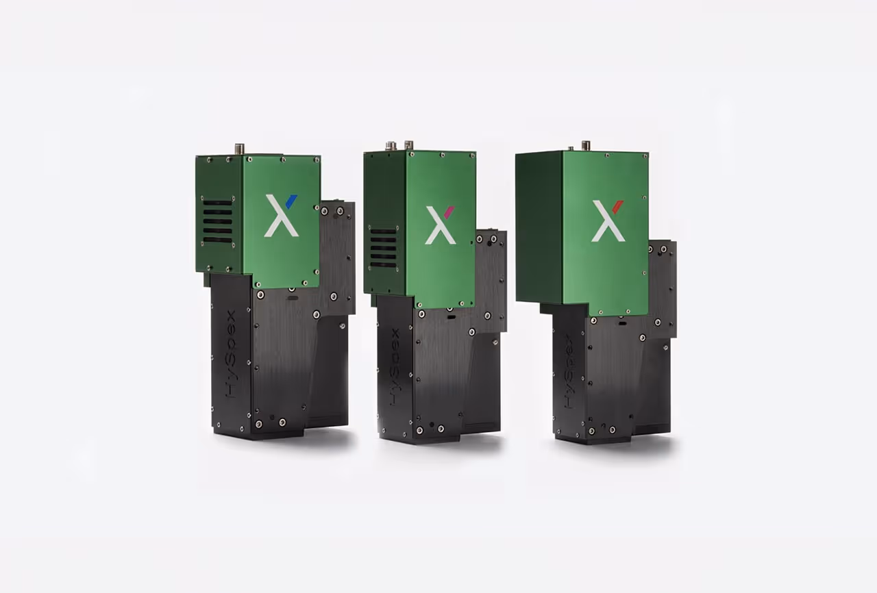 Three green and black HySpex imaging spectrometer units with different colored accents on a white background.