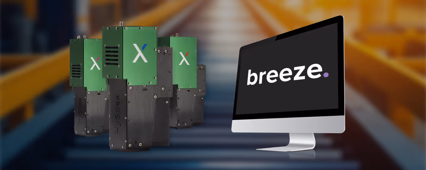 Three industrial green and black gas analyzers with 'HySpex' branding next to a computer monitor displaying the word 'breeze.'