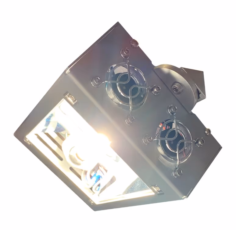 Rectangular industrial light fixture with two cooling fans on top and a bright bulb emitting light.