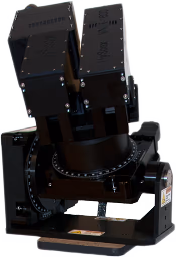Black scientific instrument with two rectangular components mounted on a rotational stage base.
