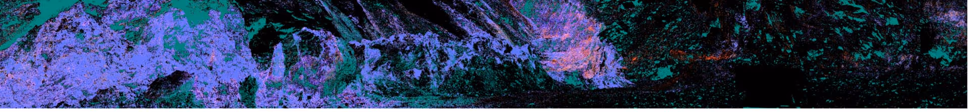 Color-enhanced satellite image showing mountain terrain with varying shades of purple, green, and black.