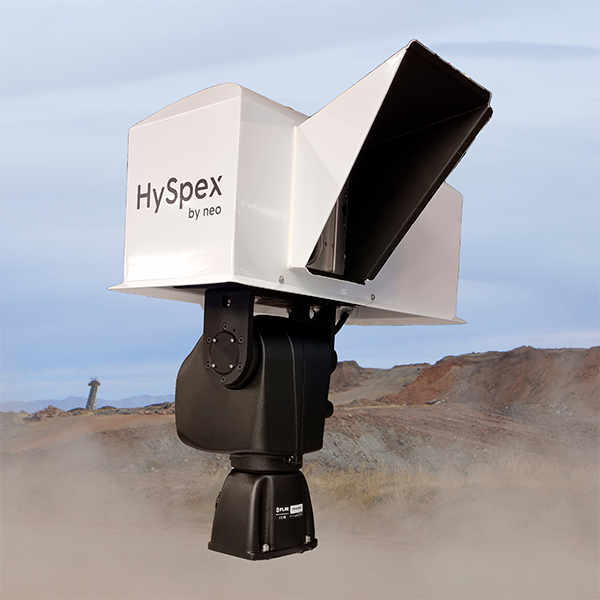 HySpex by NEO hyperspectral camera inside an IP65-certified casing for outdoors use with a desert landscape and hills in the background.