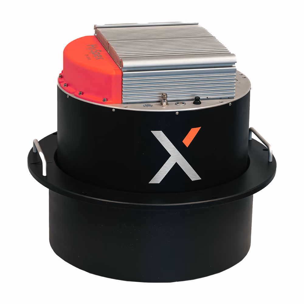 A round black hyperspectral device with a chrome metal top, a stylized "X" in the middle, and a bright red part on top