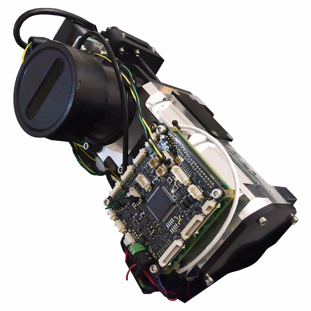 A HySpex Mjolnir OEM hyperspectral camera device with a circuit board, wiring, and cylindrical component mounted on a black and white frame.
