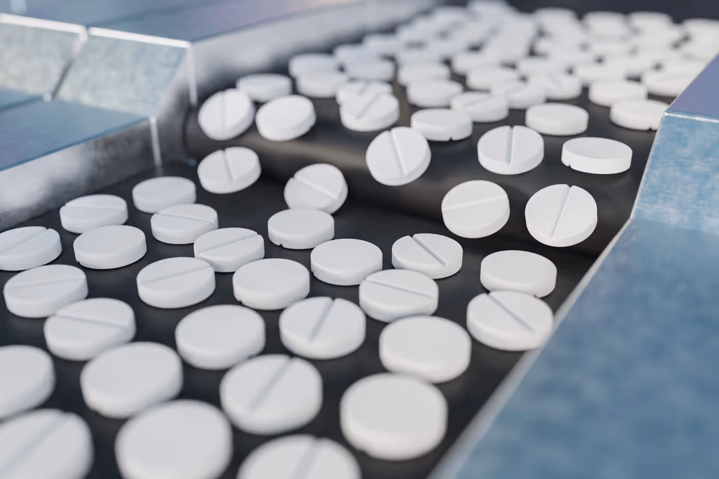 Many pharmaceutical pills on a conveyor belt