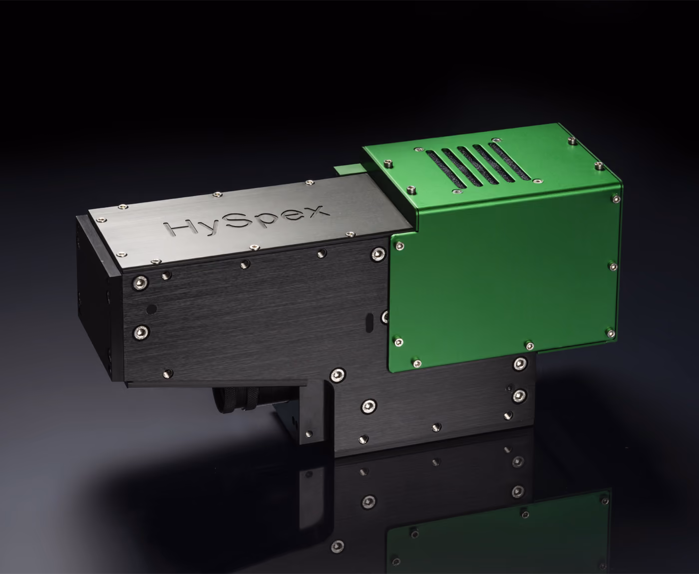 A Green HySpex Baldur hyperspectral camera on a black background