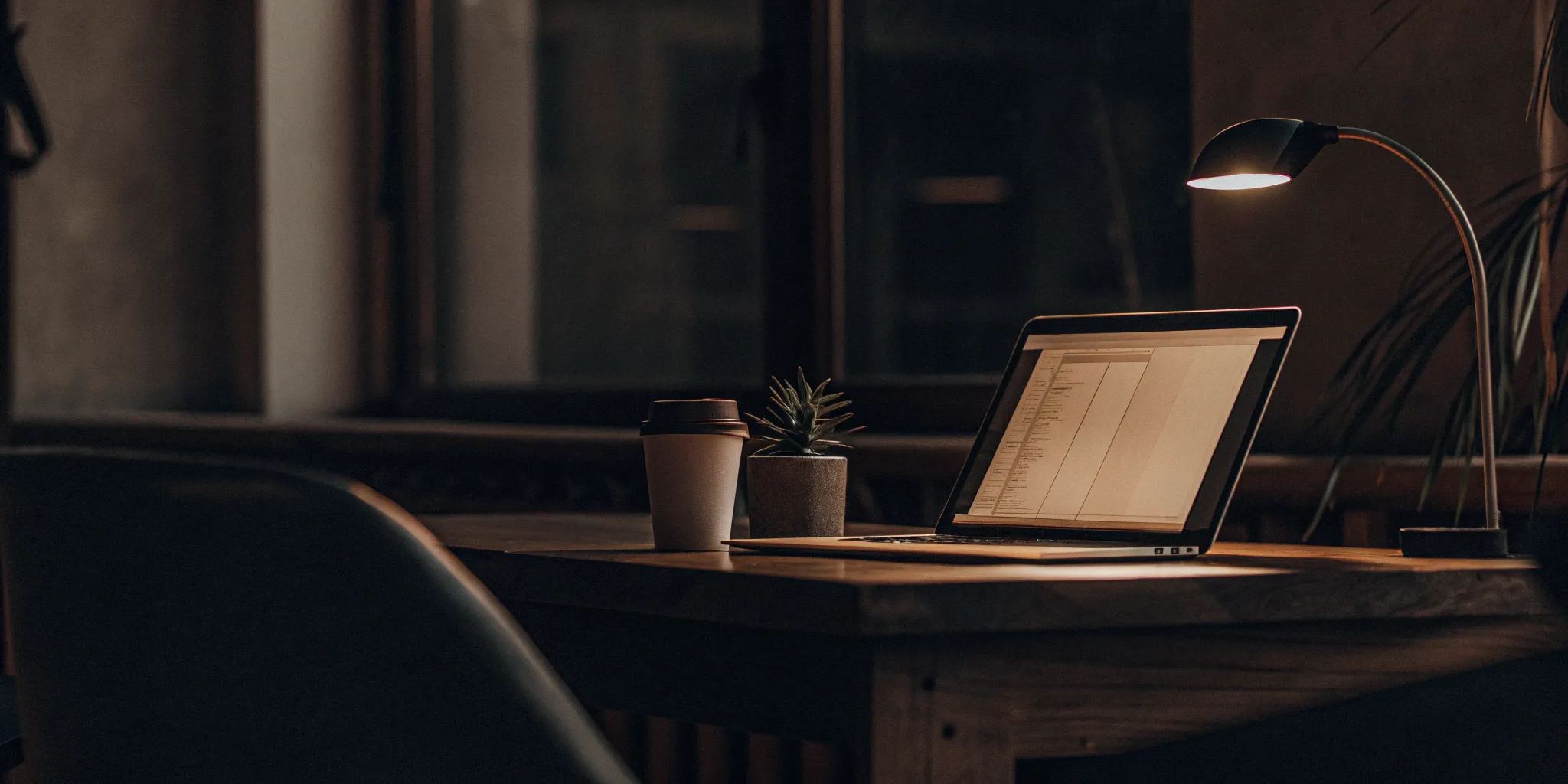 Laptop on a desk showing a rental screening report for a tenant application.