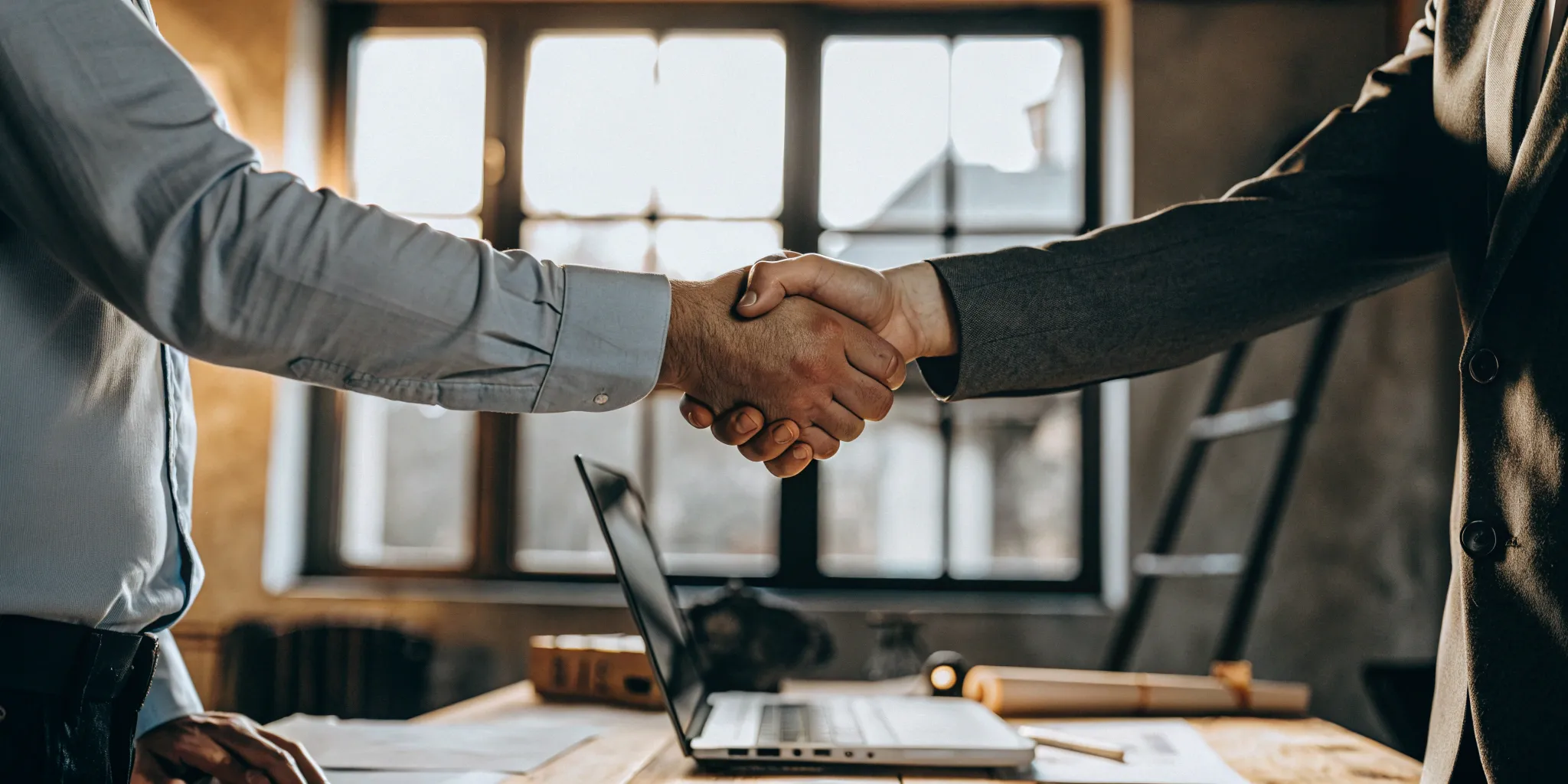 Landlord and applicant shaking hands after an approved instant tenant background check.