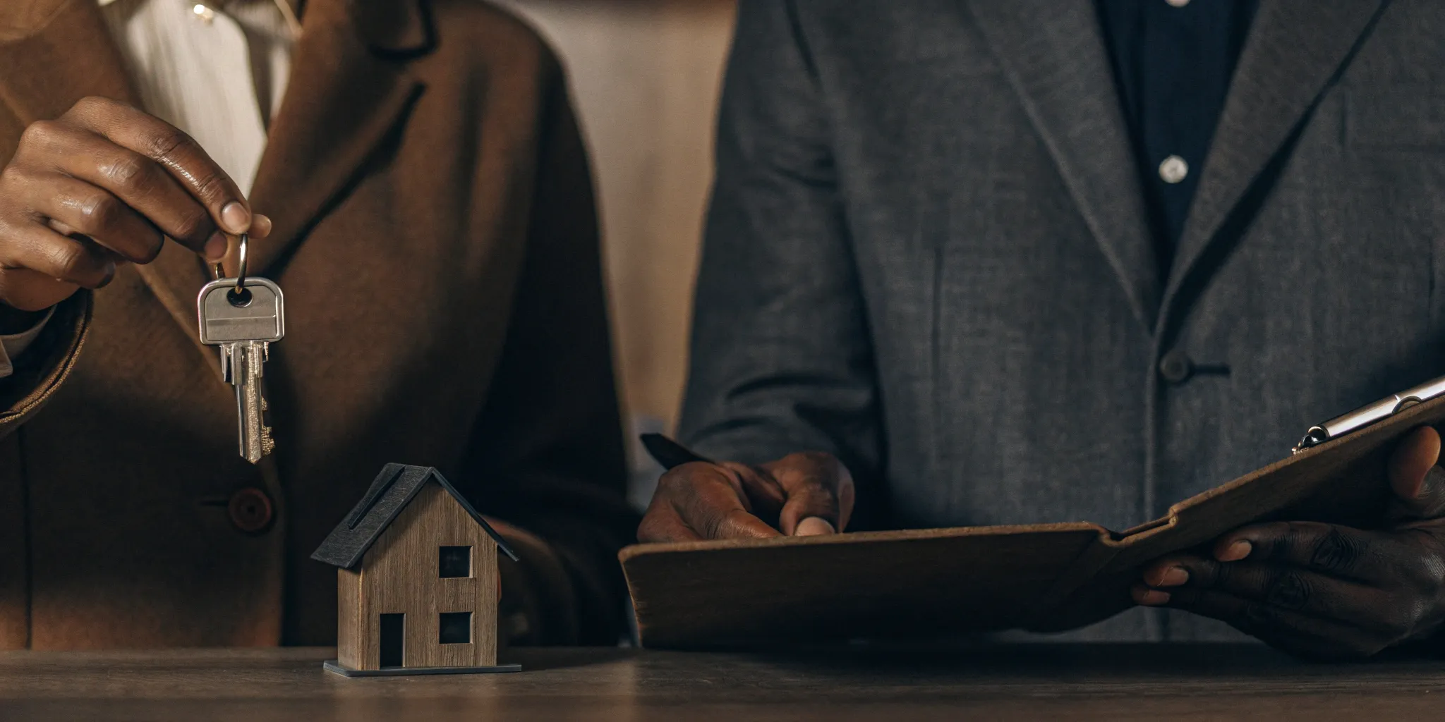 A landlord and tenant sign a lease after a successful Washington tenant screening.