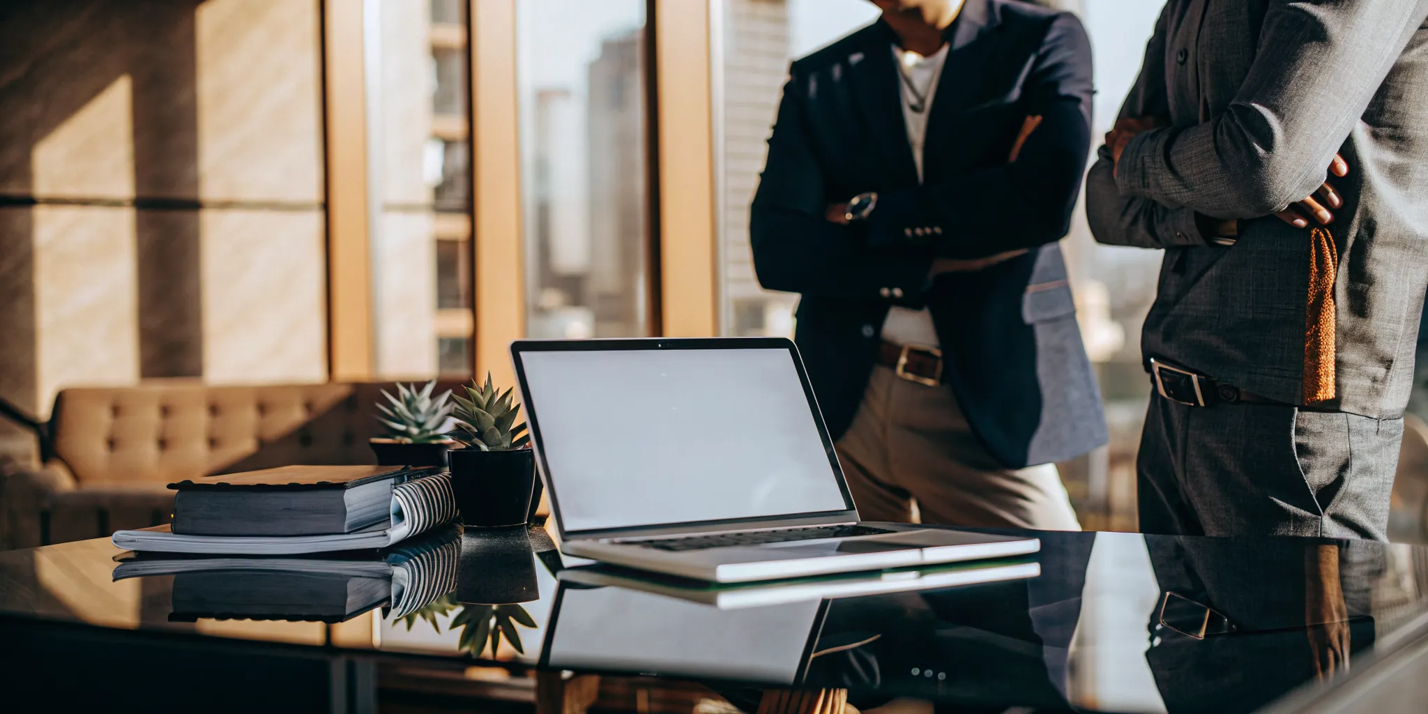 A renter and landlord review a reusable renter background report on a laptop.