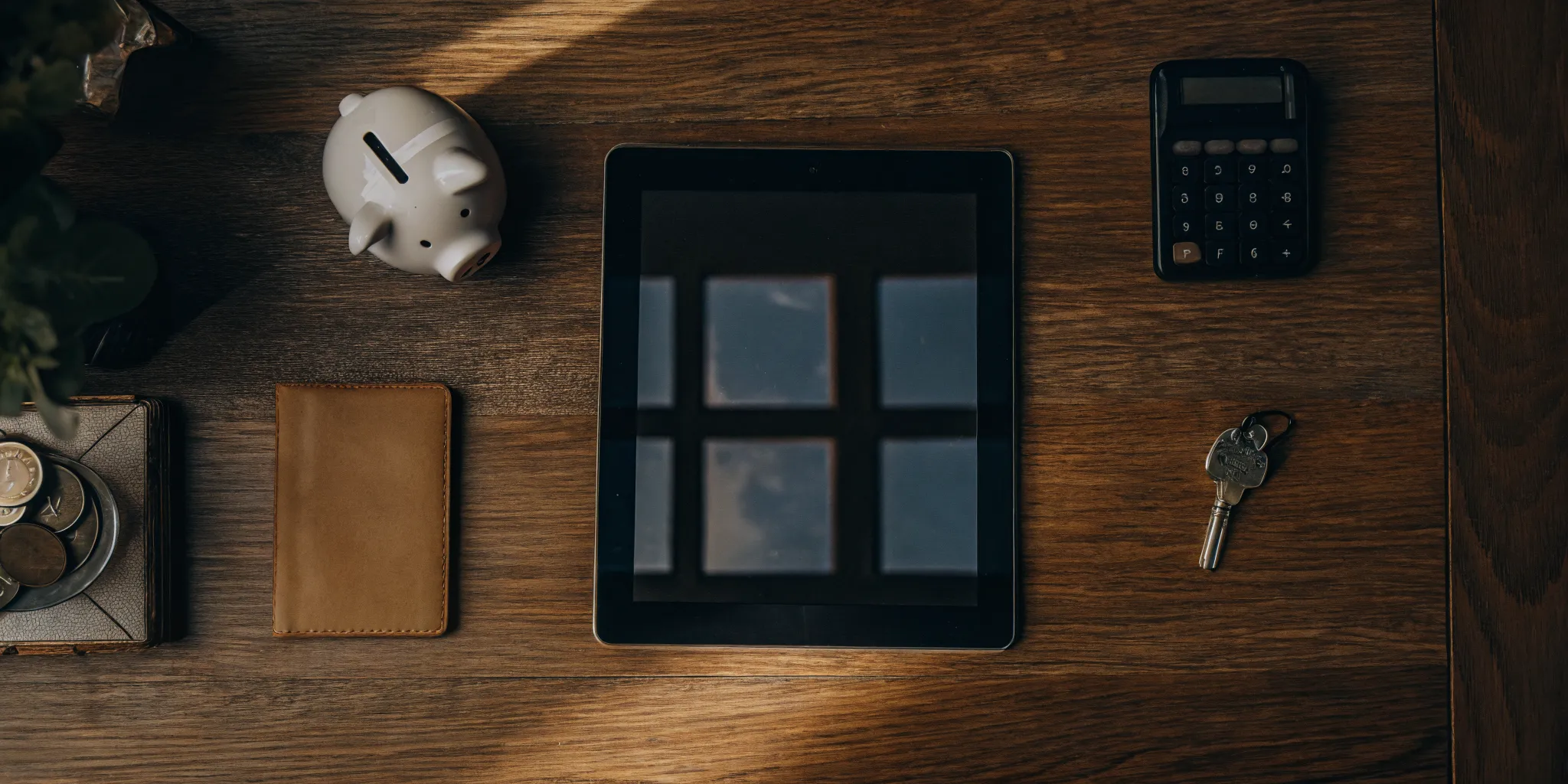 Calculating how to reduce rental application costs with a piggy bank, wallet, and calculator.