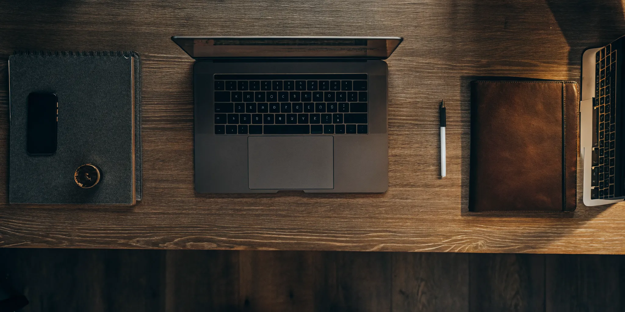 A landlord's desk with a laptop used to get a tenant credit and eviction report.