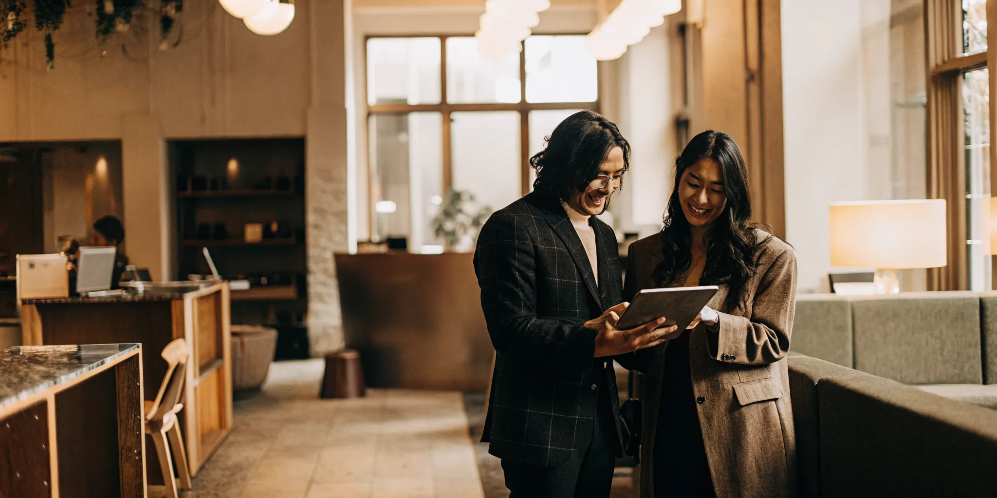 A landlord and renter reviewing a portable tenant screening report together