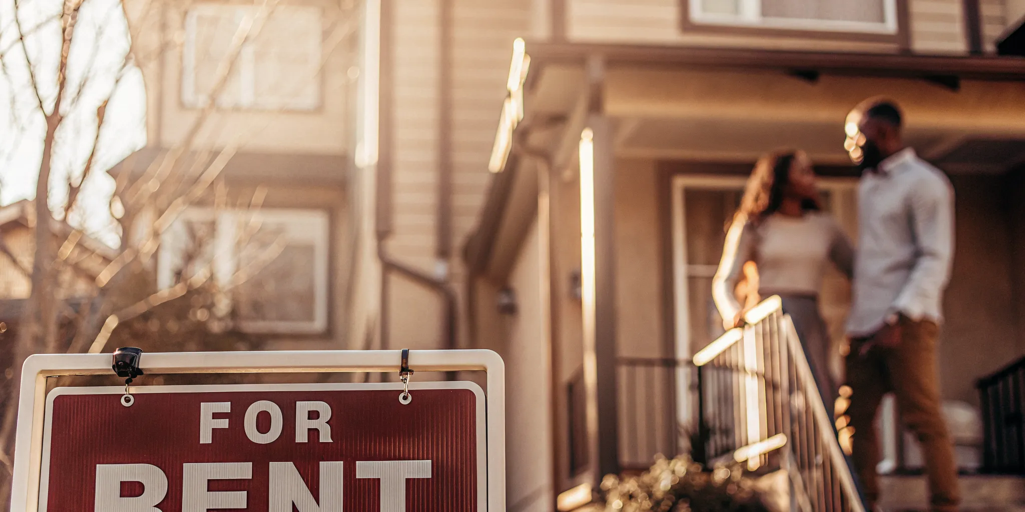 Modern apartment building in Oregon with tenant screening documents and a For Rent sign