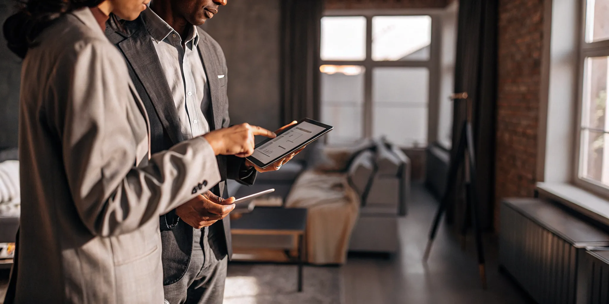 Property manager reviewing a rental application with a prospective tenant in a bright modern apartment