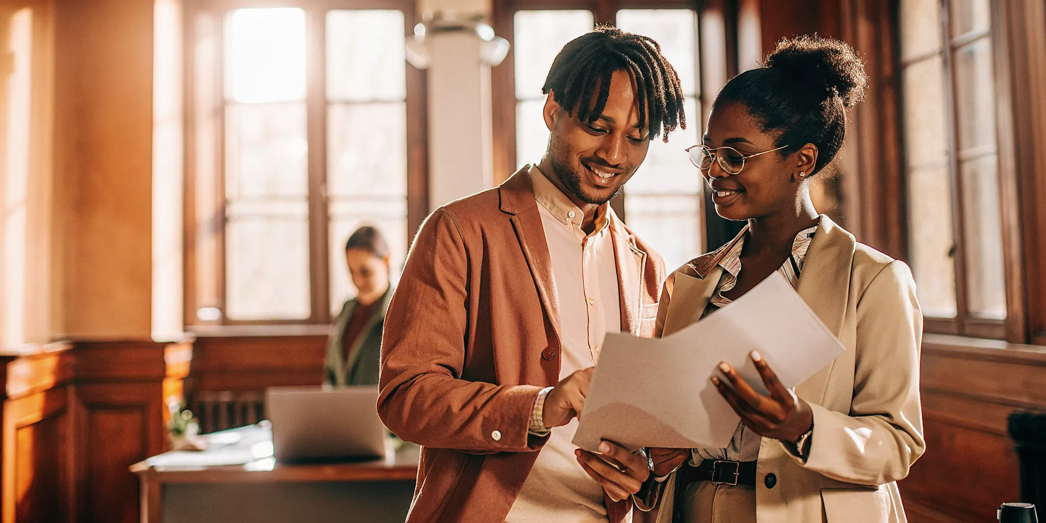 Property manager and renter reviewing a rental application as part of a tenant background check.