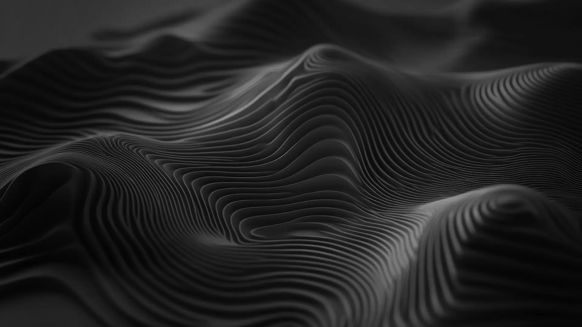 Black and gray layered abstract waves creating a 3D topographic landscape effect.