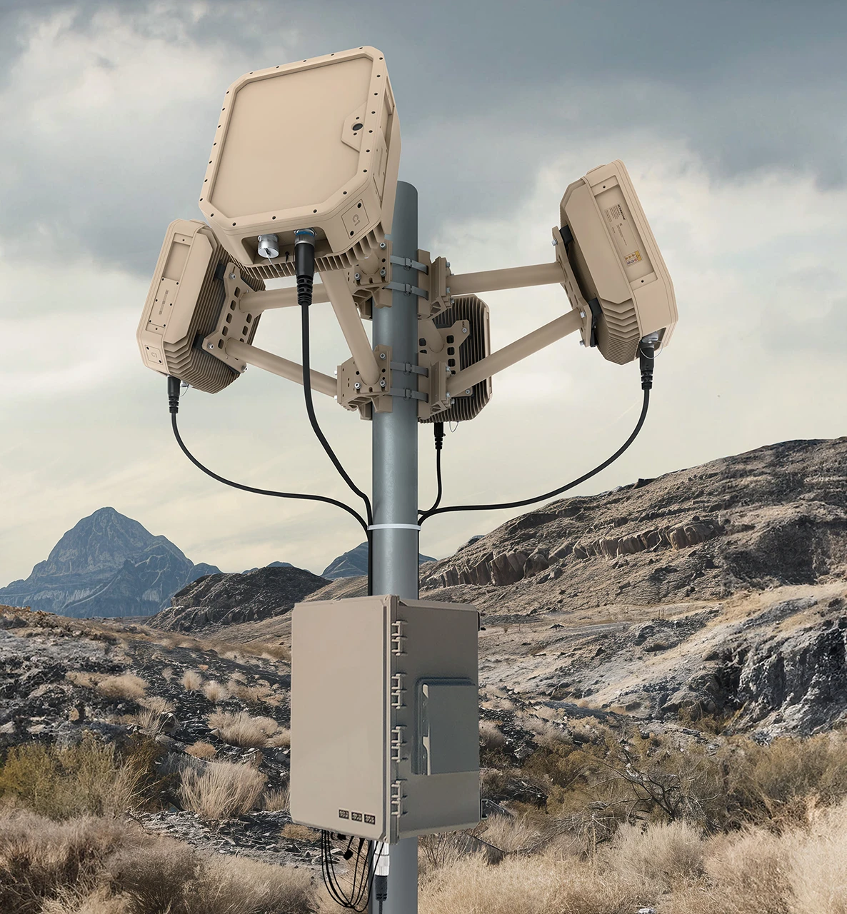 Beige electronic EchoShield radars mounted on a metal pole in a rocky desert landscape with mountains in the background.