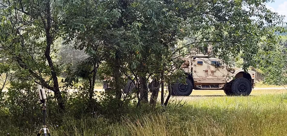 Grey vehicle with mounted EchoShield radars against a black background with grey hexagon pattern