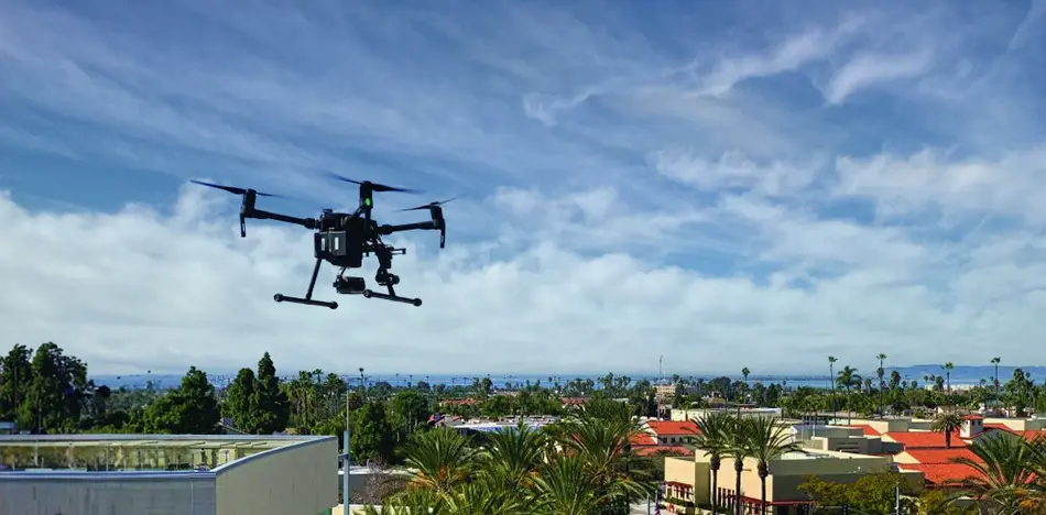 Grey vehicle with mounted EchoShield radars against a black background with grey hexagon pattern