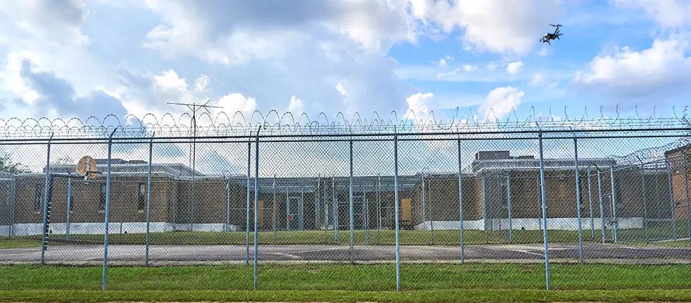 Grey vehicle with mounted EchoShield radars against a black background with grey hexagon pattern
