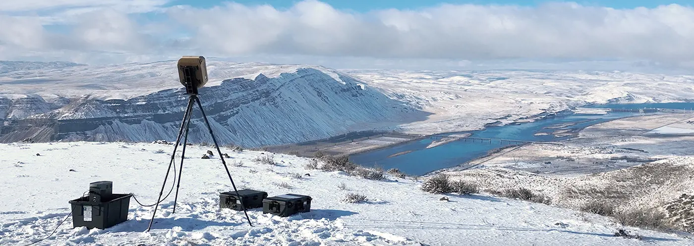Grey vehicle with mounted EchoShield radars against a black background with grey hexagon pattern
