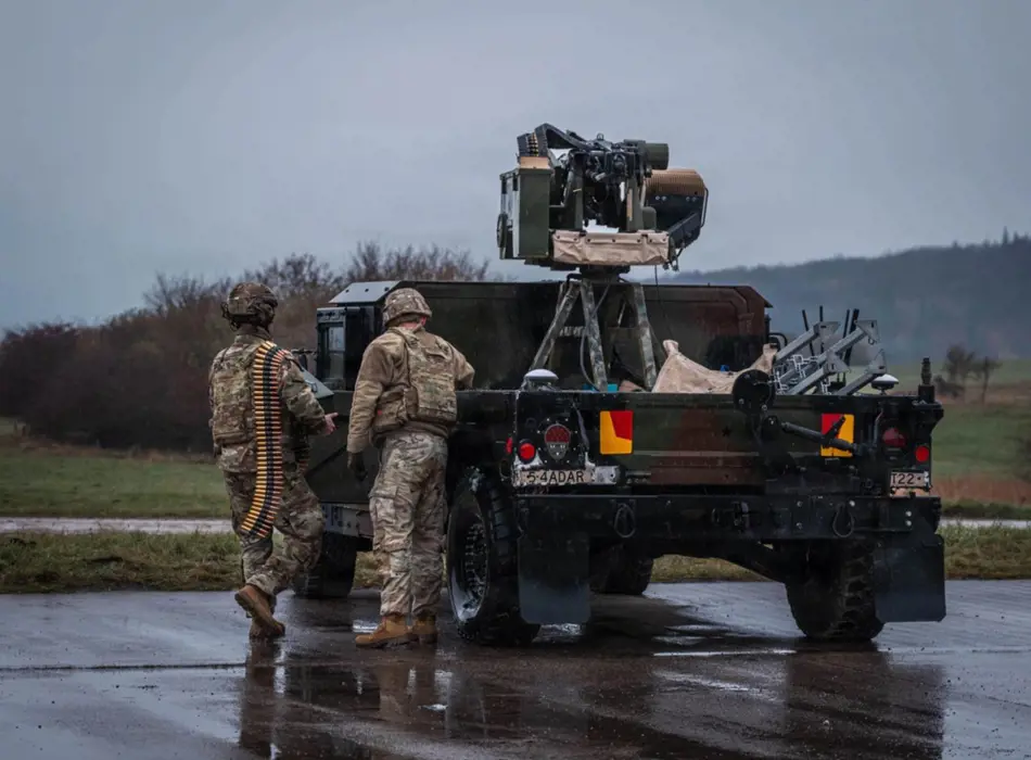 Grey vehicle with mounted EchoShield radars against a black background with grey hexagon pattern