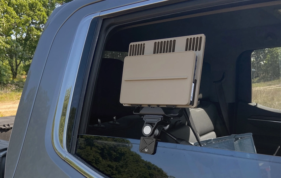 Grey vehicle with mounted EchoShield radars against a black background with grey hexagon pattern