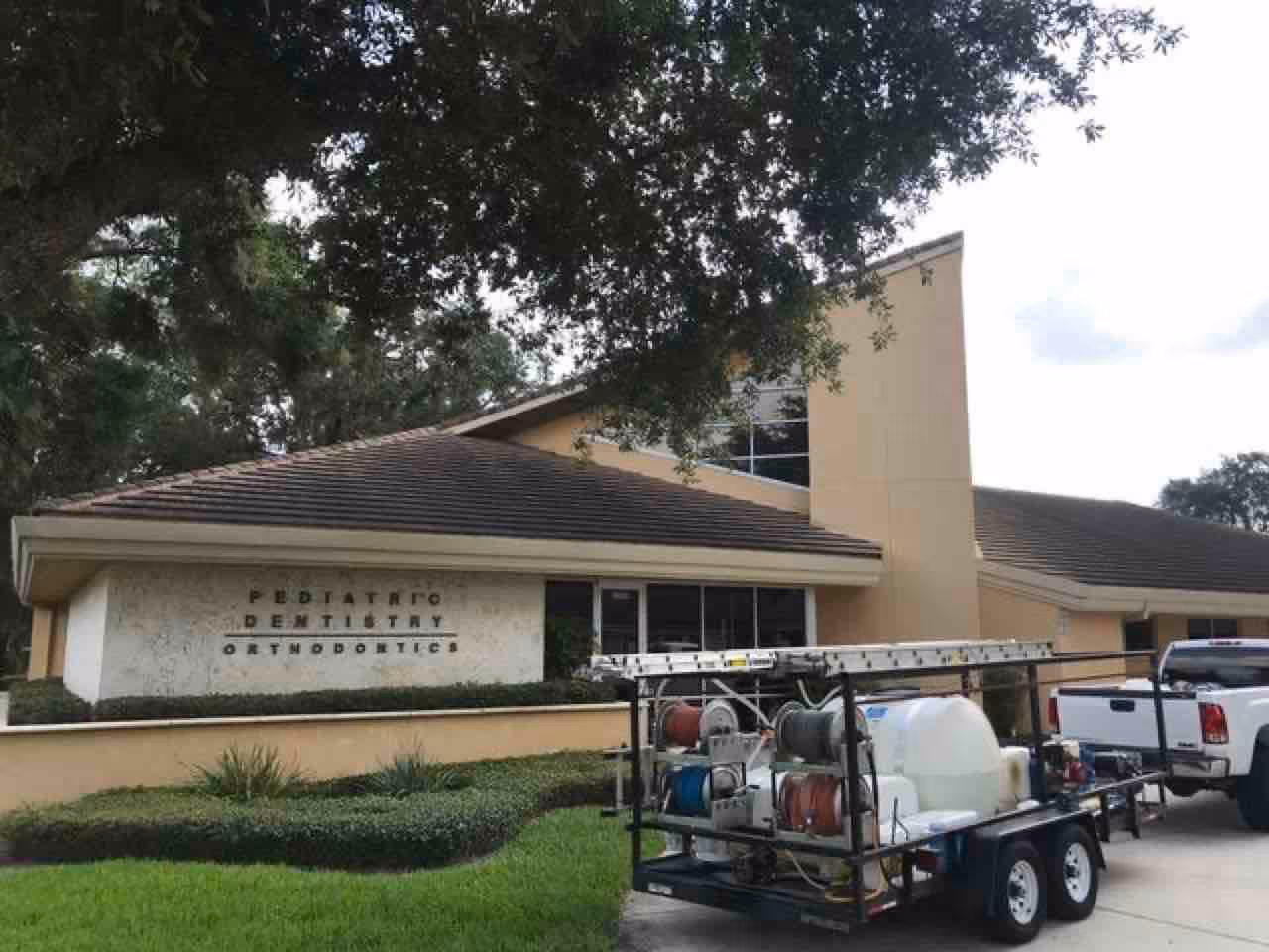 Roof soft washing Longwood equipment and low-pressure application on Florida home exterior