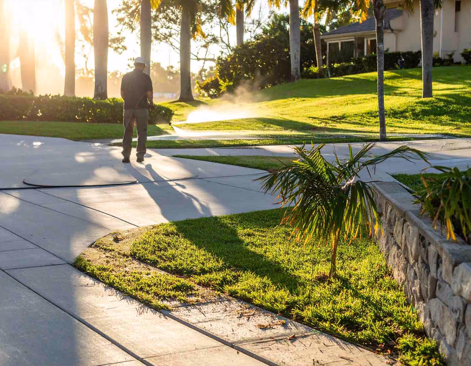 Before and after pressure washing Longwood FL by Ragin Cajun Soft Wash showing clean concrete surfaces