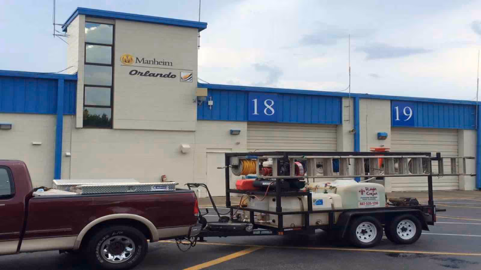 Ragin Cajun Soft Wash crew performing commercial pressure washing on shopping center parking lot
