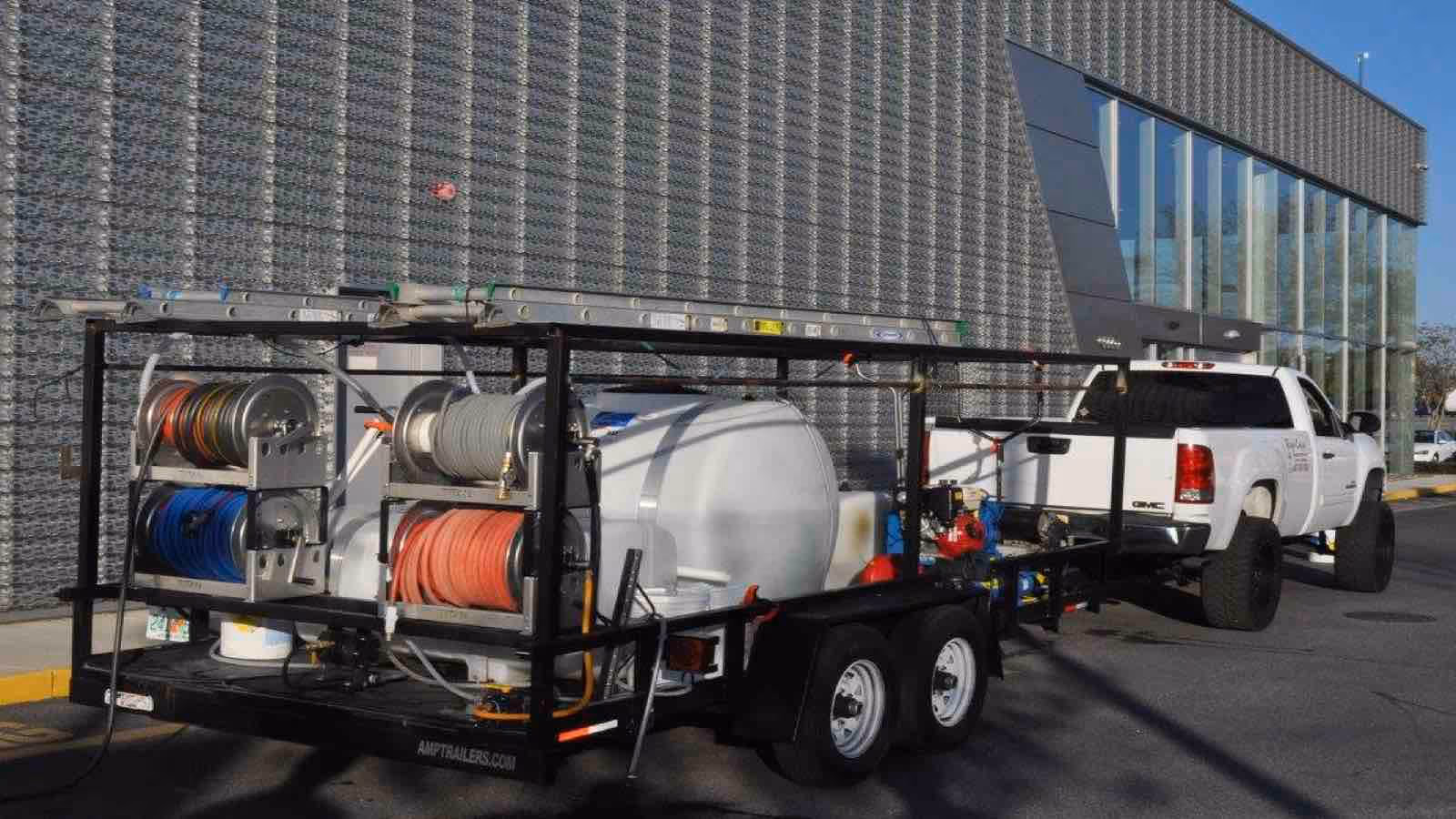 Commercial pressure washing by Ragin Cajun Soft Wash removing grime from office building exterior walls