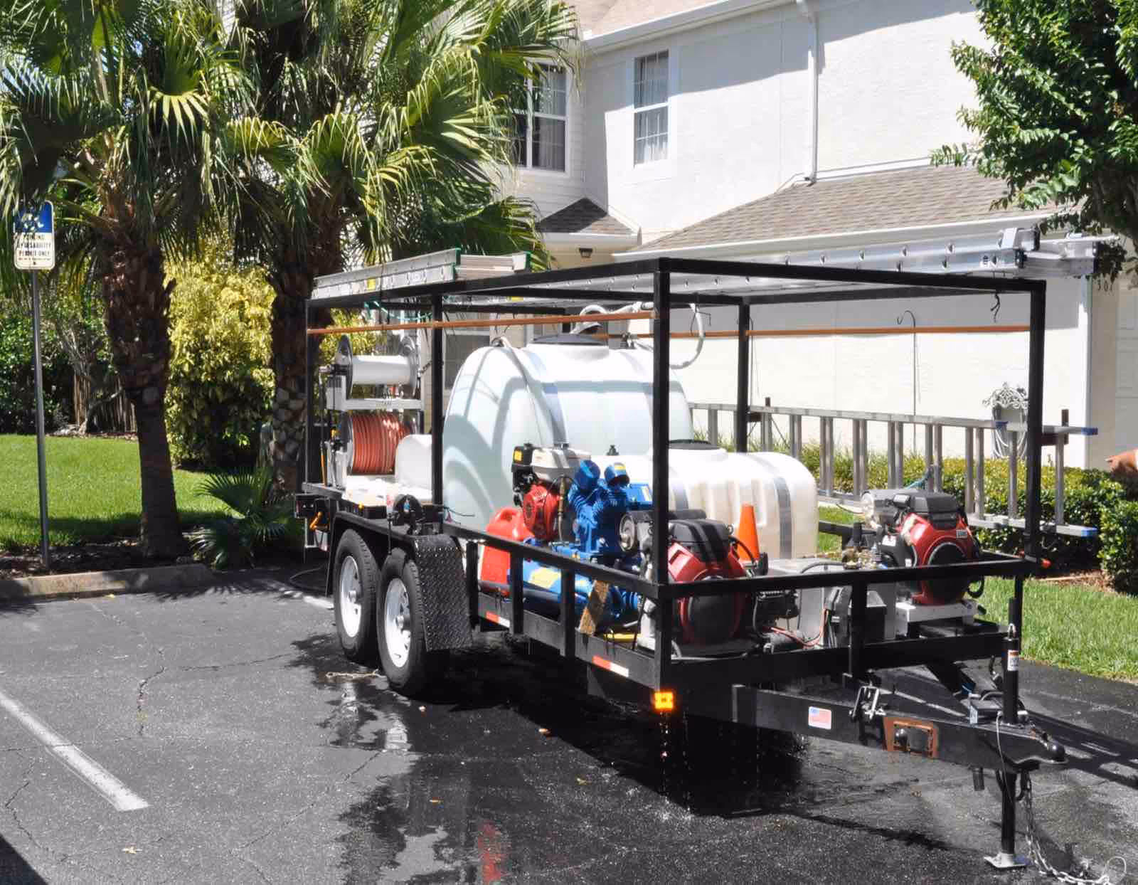 Ragin Cajun Soft Wash technician performing driveway pressure washing on residential home entrance