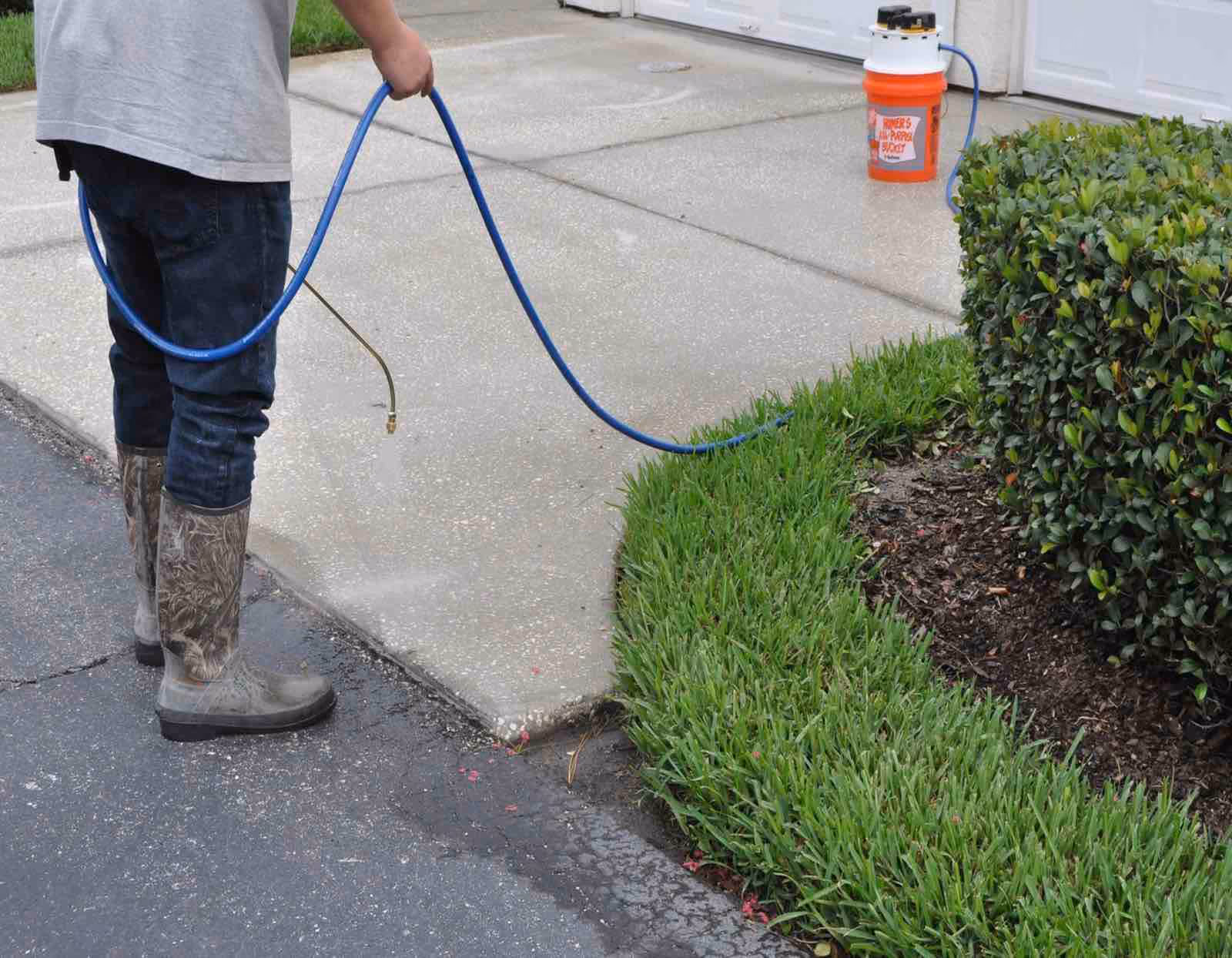 Ragin Cajun Soft Wash driveway pressure washing removing oil stains and tire marks from concrete