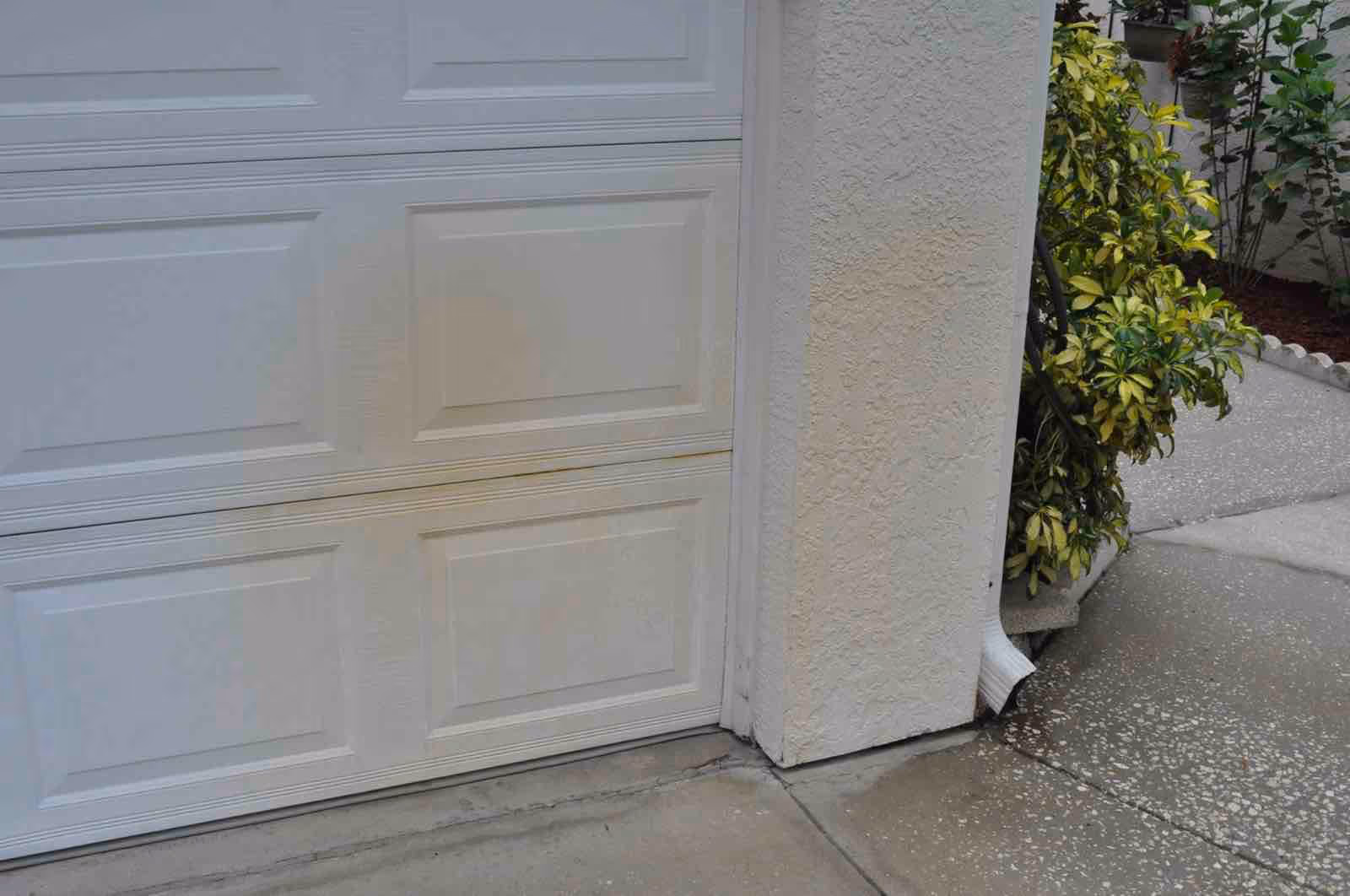 Ragin Cajun Soft Wash technician performing irrigation rust removal Longwood on sidewalk and driveway edges