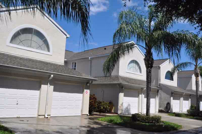 Close-up of roof pressure washing process restoring dark shingles to original appearance in Central Florida