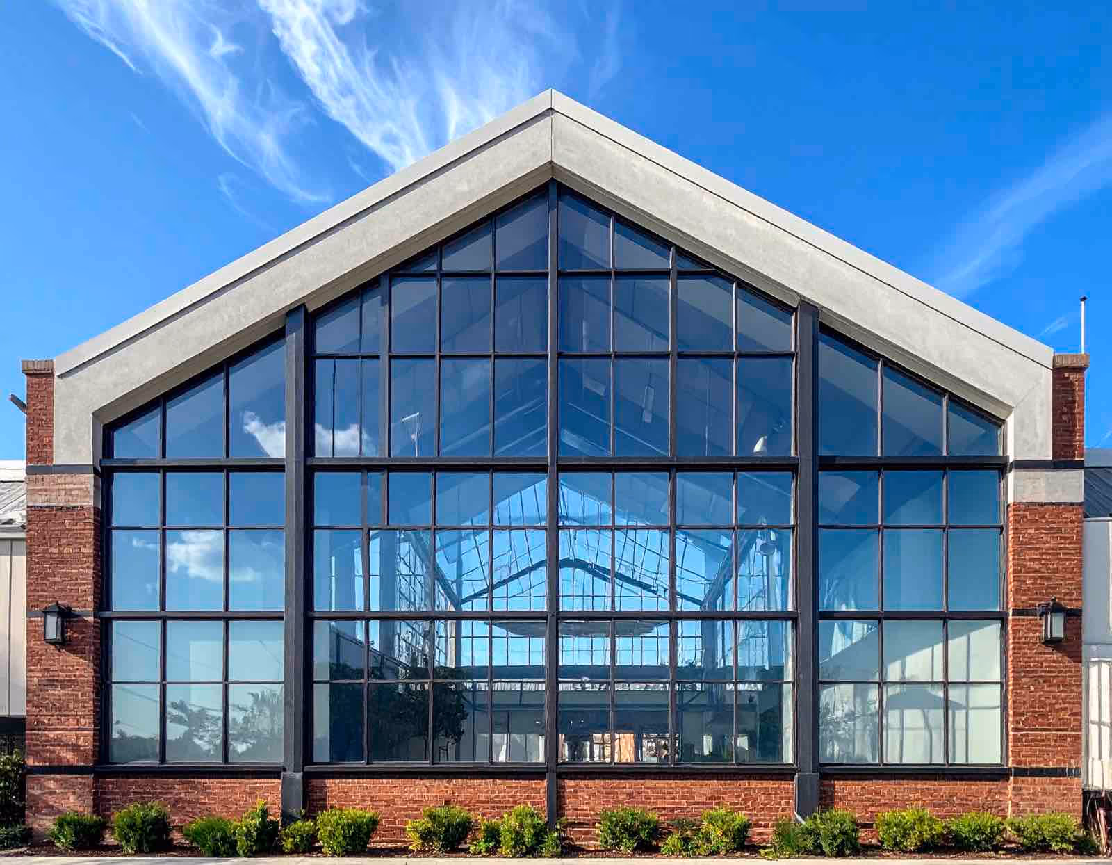 Professional industrial window cleaning crew using rope access system on multi-story office building exterior