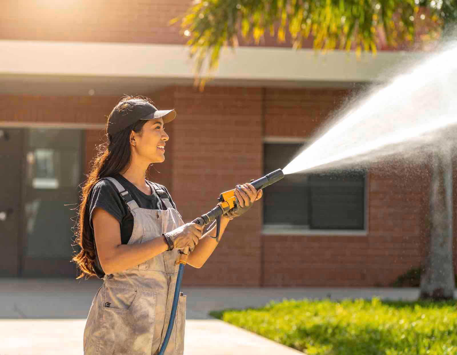 School window cleaning specialist treating high windows and glass doors at educational facility in Central Florida