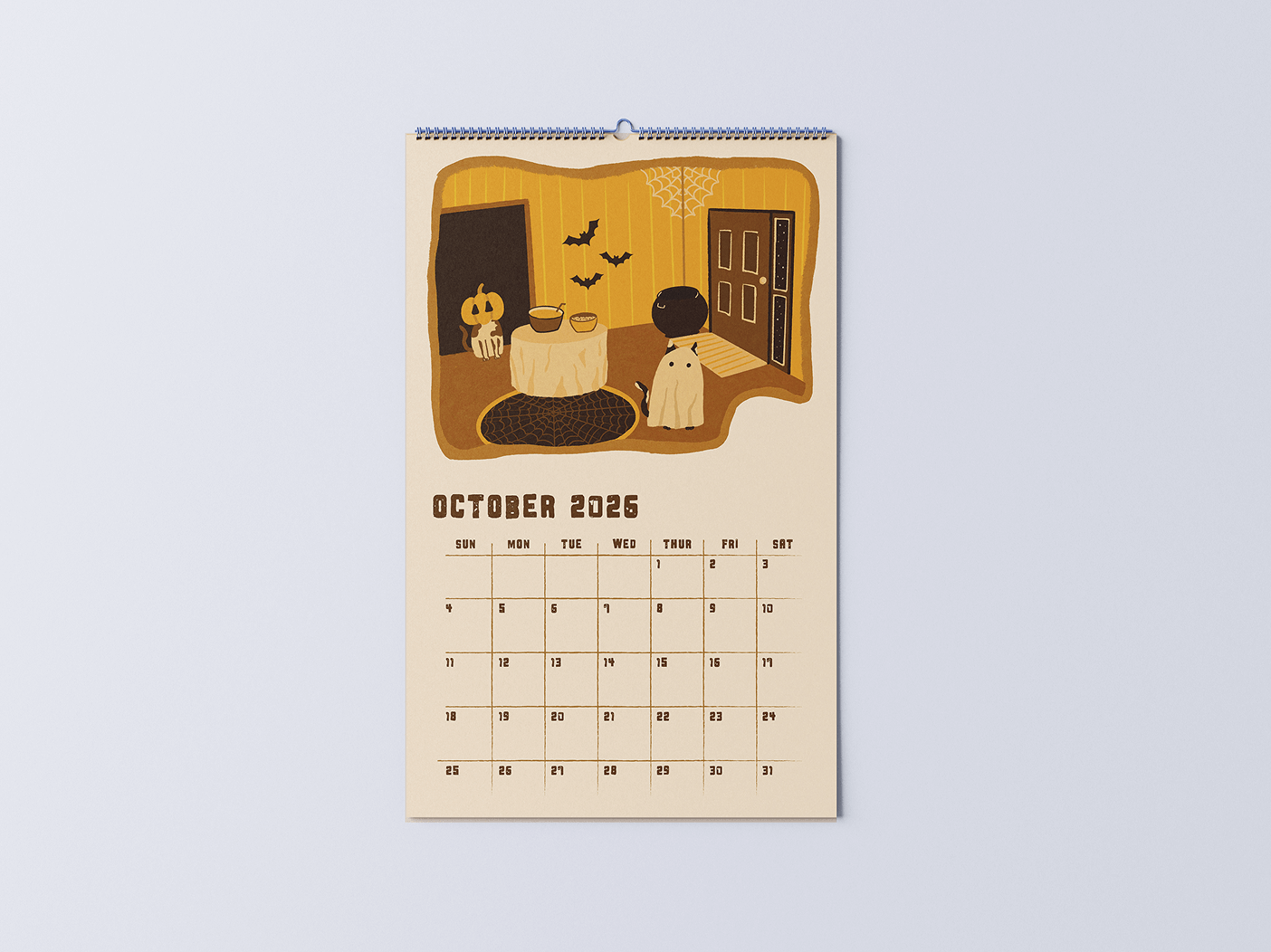 October 2026 calendar page with a Halloween-themed illustration of two cats dressed in costumes inside a room decorated with bats and a spiderweb.