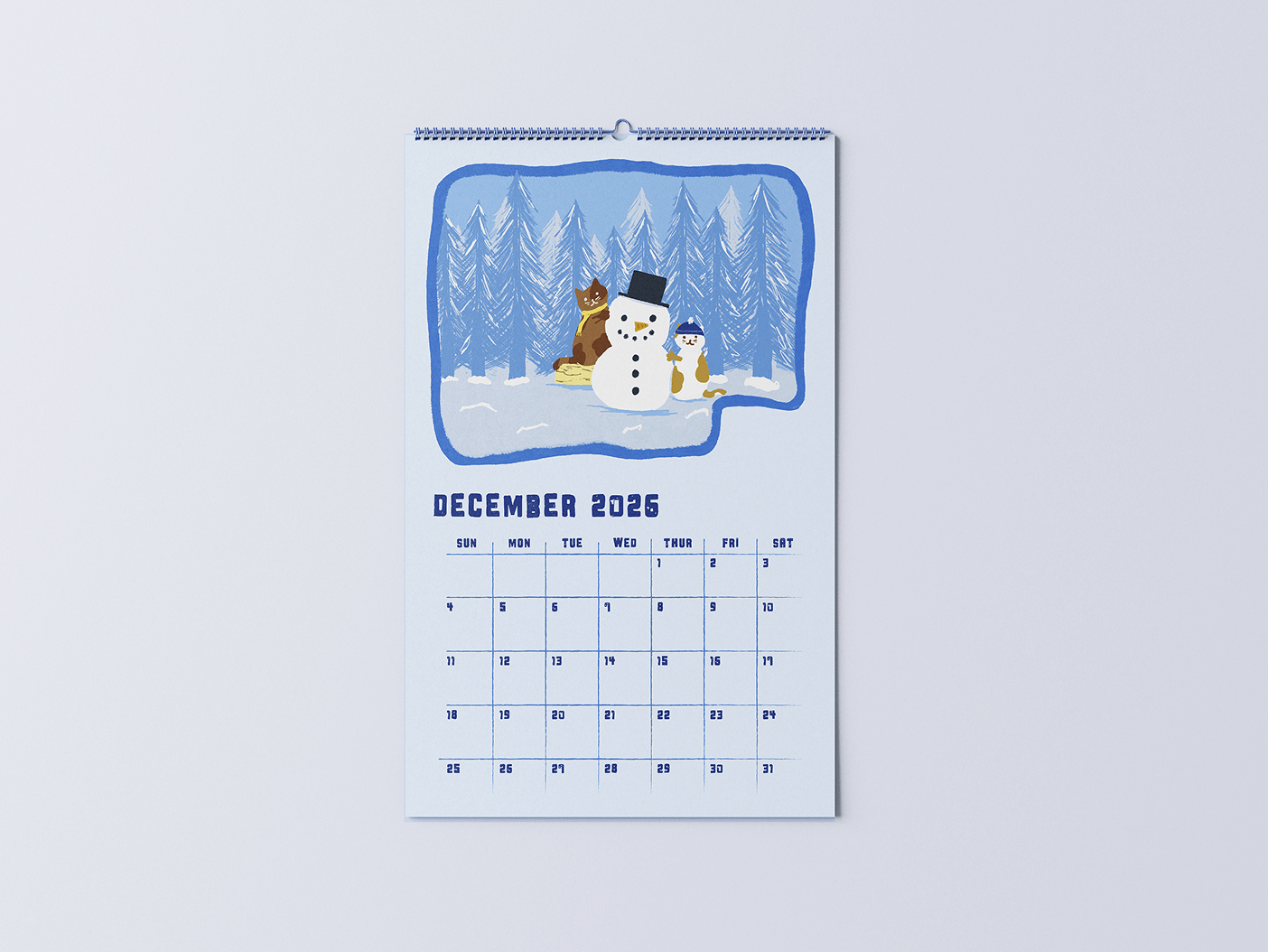 December 2026 wall calendar with illustration of a snowman, two cats, and pine trees in snow.