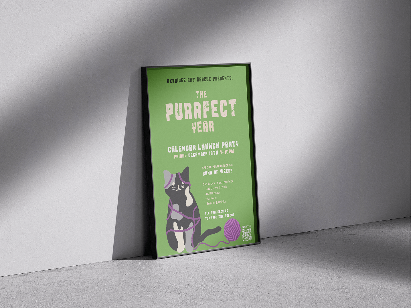 Framed green poster leaning against a wall promoting Uxbridge Cat Rescue's 'The Purrfect Year' calendar launch party with a cartoon cat entangled in purple yarn.