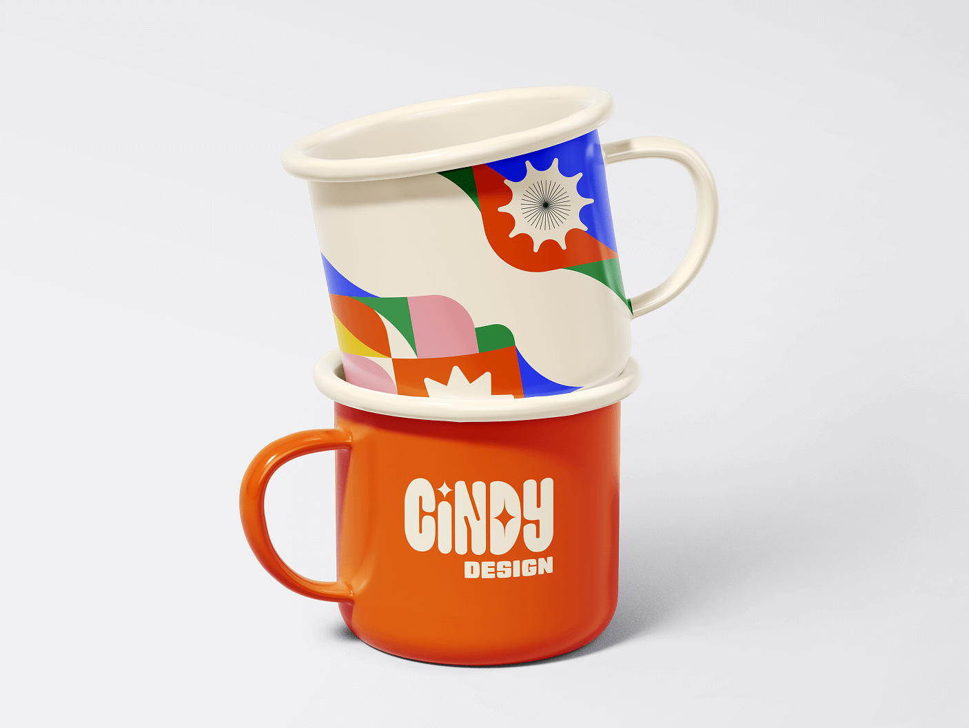 Stacked enamel mugs, the top one with colorful abstract patterns and the bottom one orange with 'CINDY DESIGN' text.