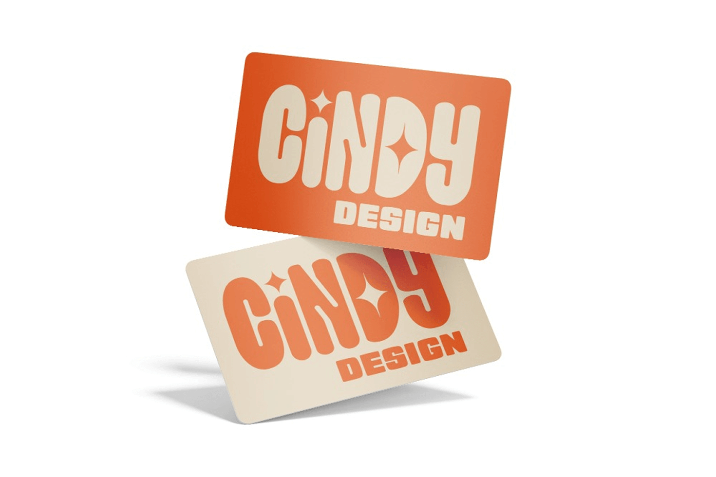 Two business cards with rounded corners, one orange with cream text and one cream with orange text, both reading 'CINDY DESIGN' in a playful font with star shapes inside the letters.