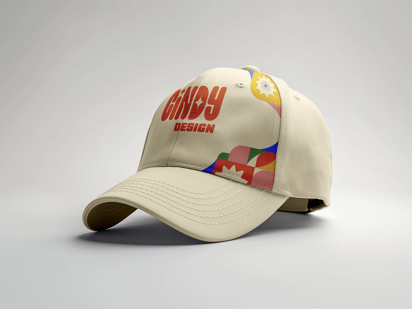 Beige baseball cap with red text reading Cindy Design and colorful geometric patterns on the side.