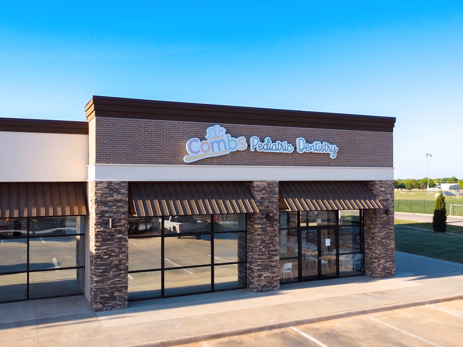 background image - a photo of Combs Pediatric Dentistry's clinic from the outside
