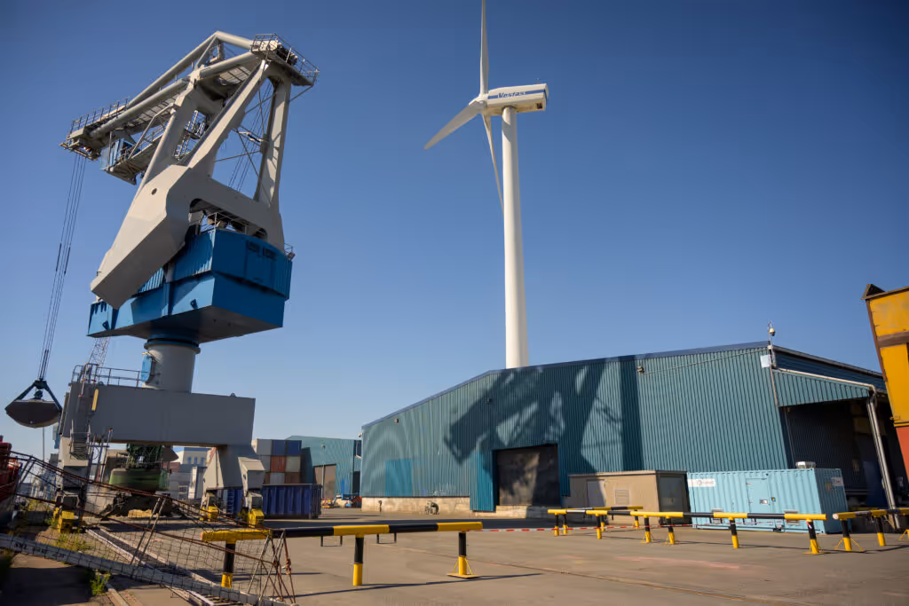 A port terminal with a wind turbine, a crane, and one of QuinteQ's flywheels