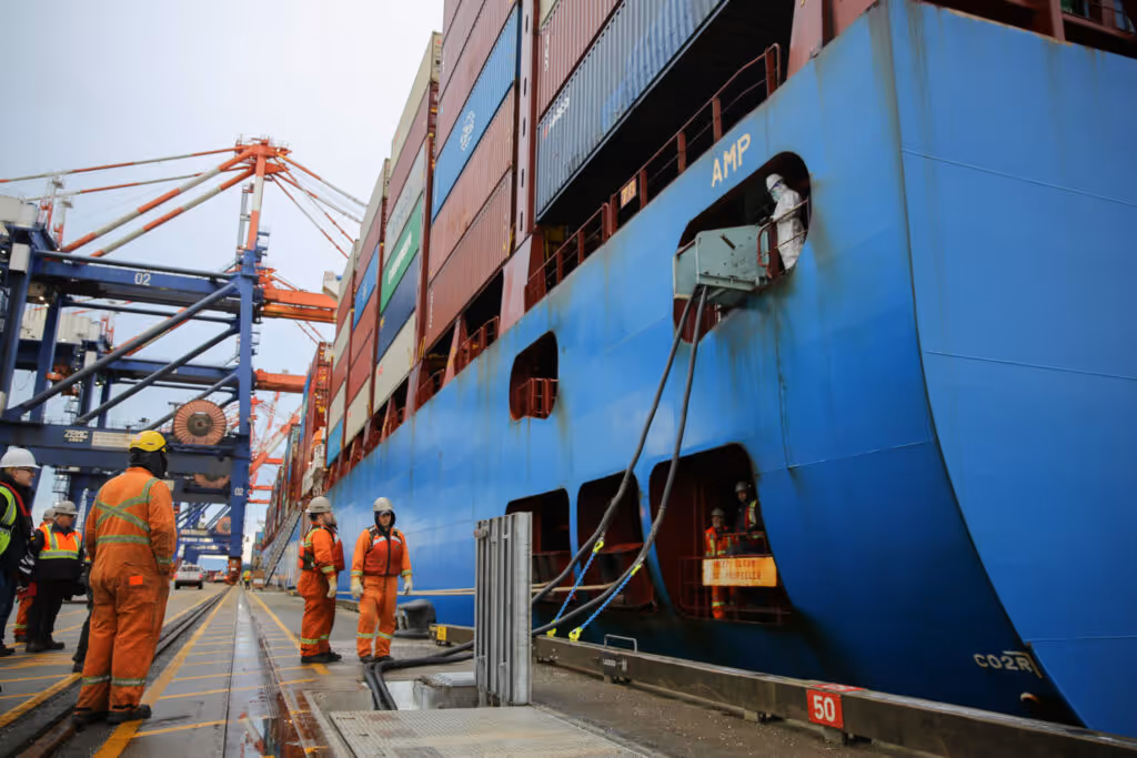 Dock workers connecting a ship to onshore power